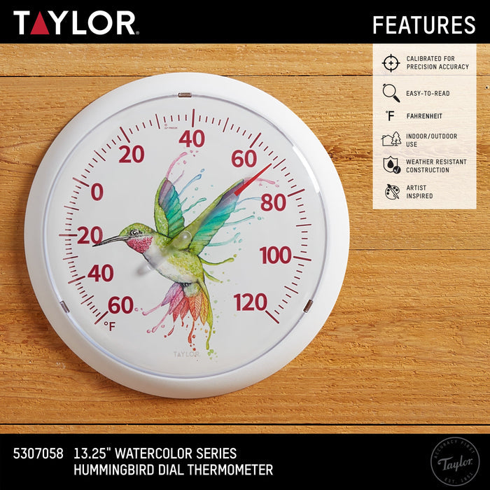 Packaging image showing a large round hummingbird thermometer on a wood background with a beige features panel