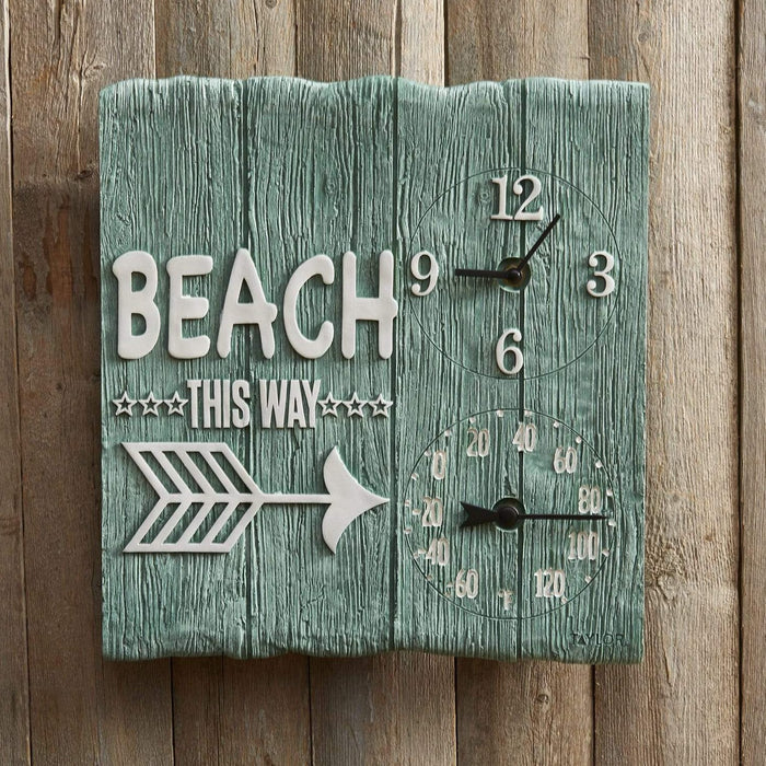 Teal wood wall clock with BEACH THIS WAY lettering and decorative arrow accents