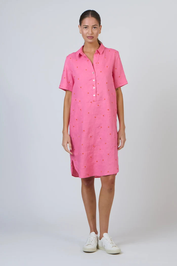 Woman wearing a pink dress with a white background