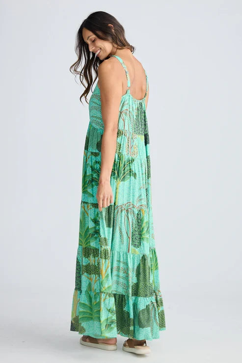 Woman wearing a green patterned dress on a white background. Holiday Trading Evianna Dress Rainforest Print