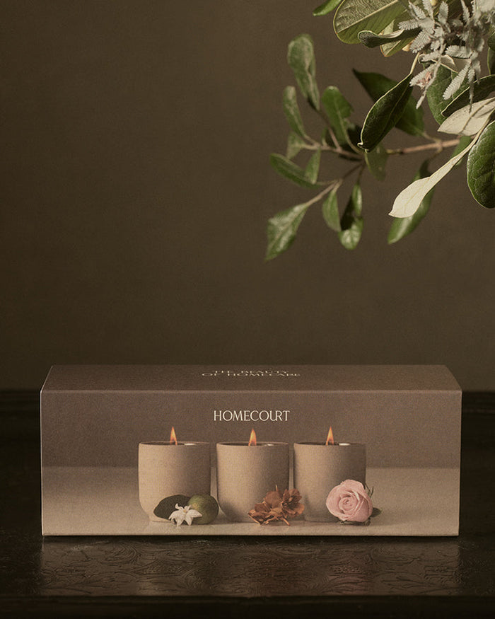 The three votives lit, in their clay vessels