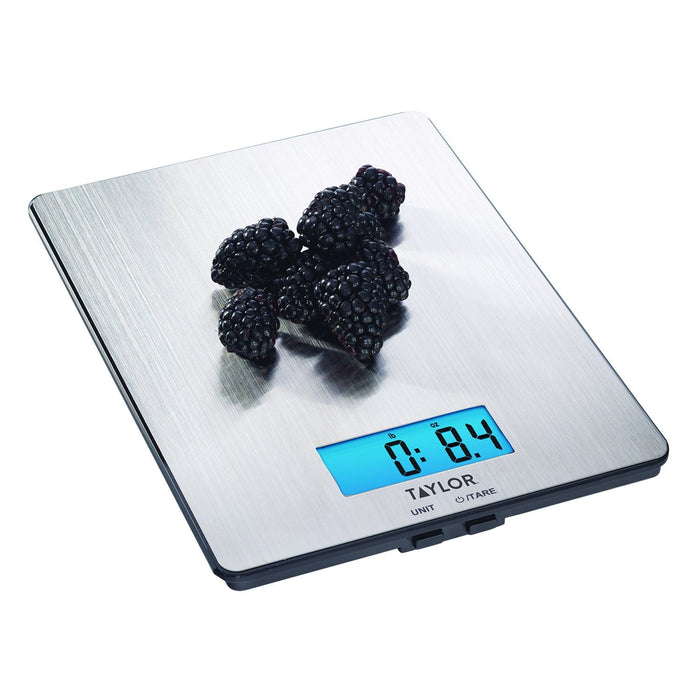 Stainless steel digital kitchen scale with blackberries on the weighing surface