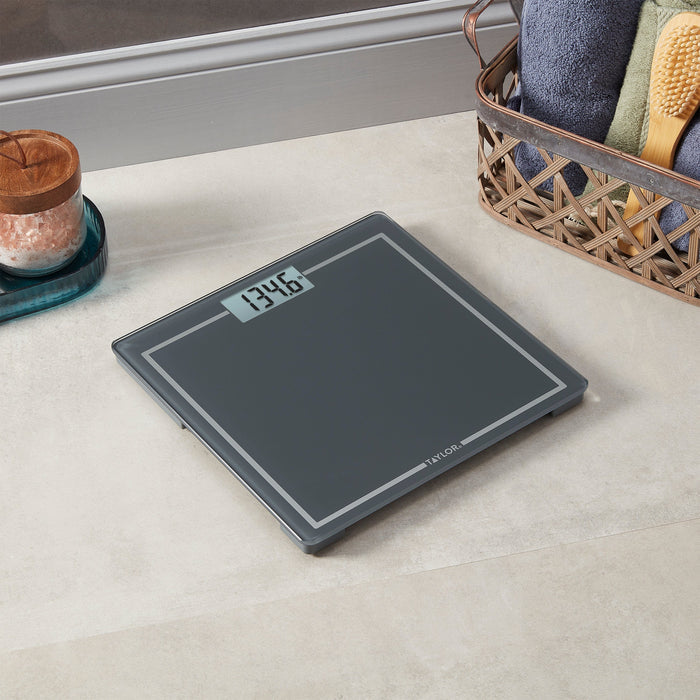 Display on the gray portable scale shows 134.6 lb beside a basket of towels and a salt lamp.