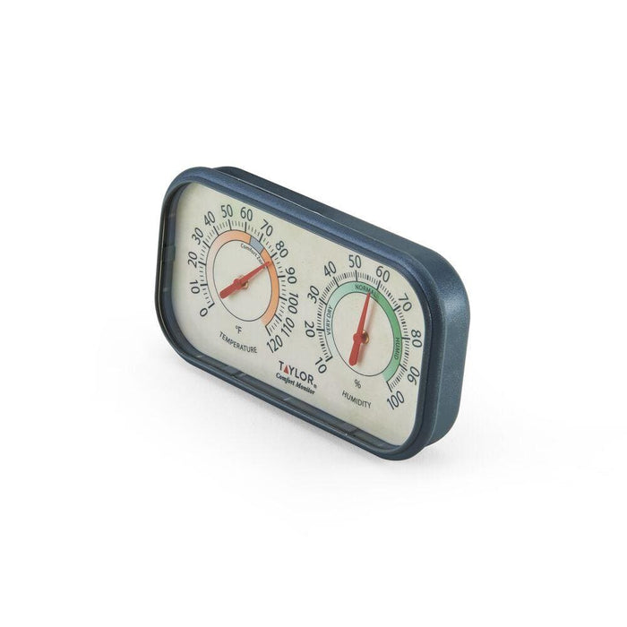 Compact Taylor Comfort Monitor with temperature and humidity dials in a blue frame viewed from an angle