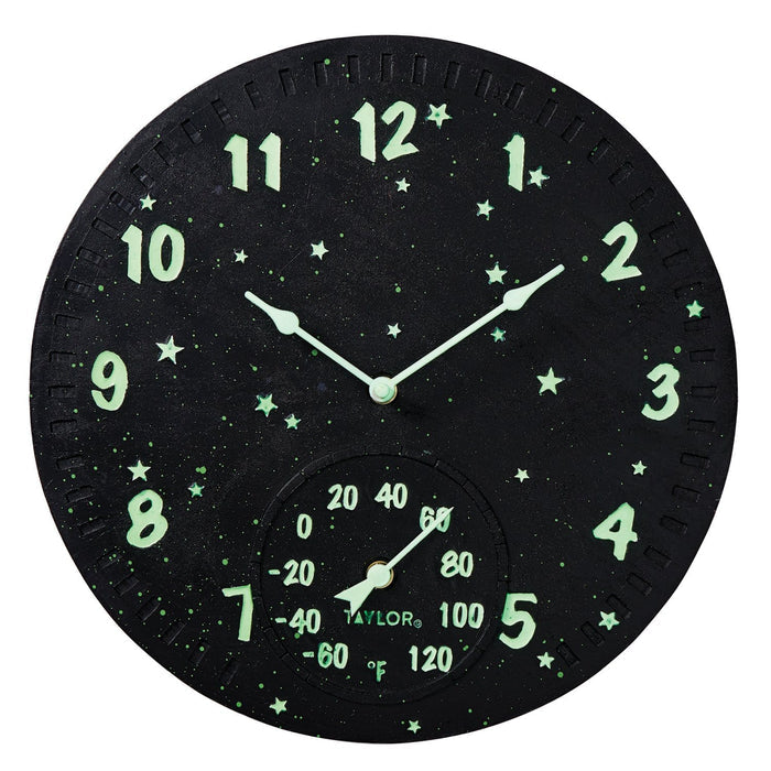 Round black galaxy clock with glowing green numbers and stars and a thermometer gauge at the bottom