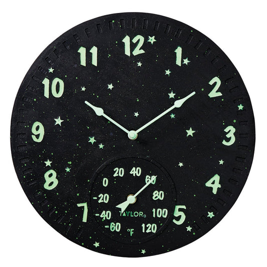 Round black galaxy clock with glowing green numbers and stars and a thermometer gauge at the bottom