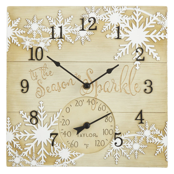 Square wooden clock with white snowflakes, bold black numerals around the edge, and a thermometer dial at the bottom.
