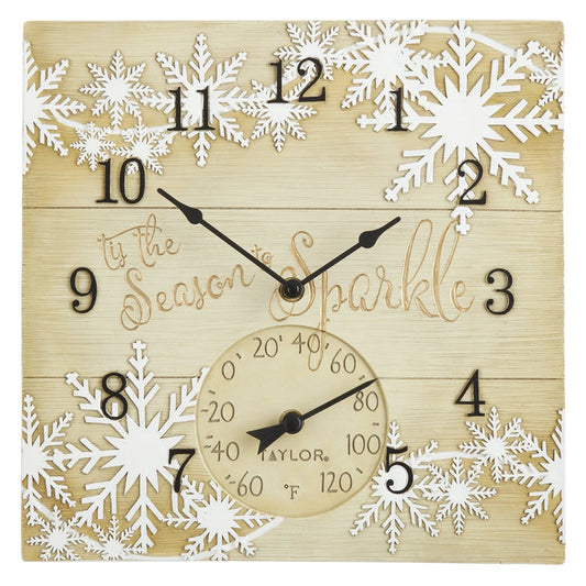 Square wooden clock with white snowflakes, bold black numerals around the edge, and a thermometer dial at the bottom.