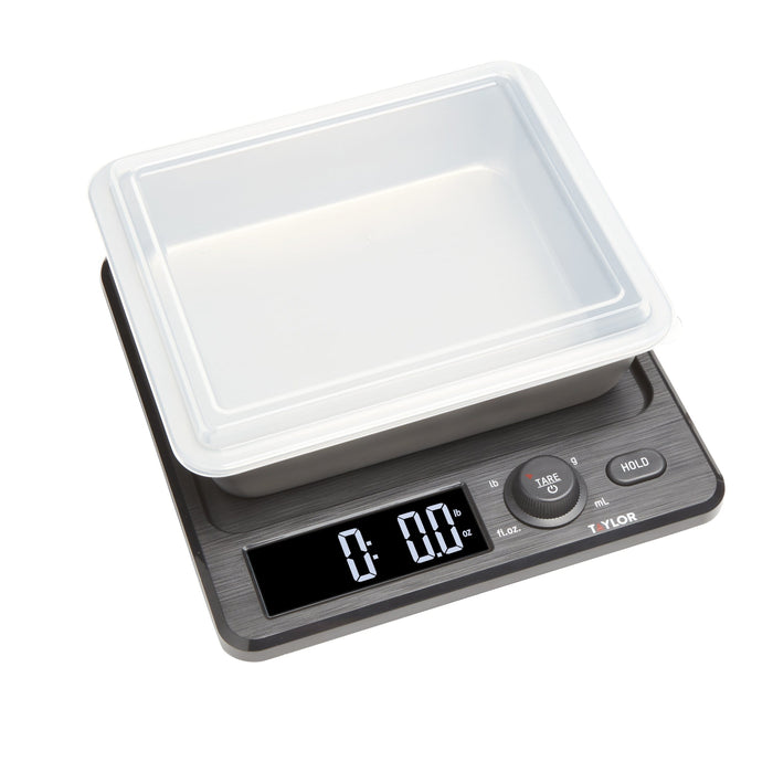 Top view of the white storage container with clear lid on the scale