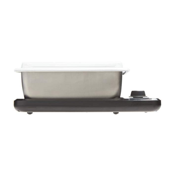 Stainless steel storage container with lid on a black kitchen scale against a white background