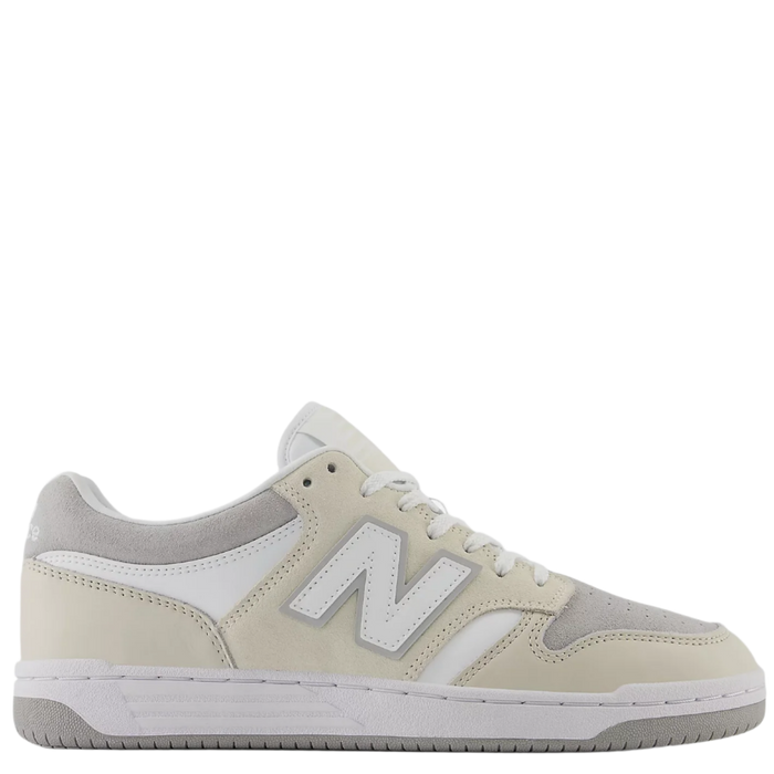 A pair of beige and white New Balance sneakers with lace-up closure.