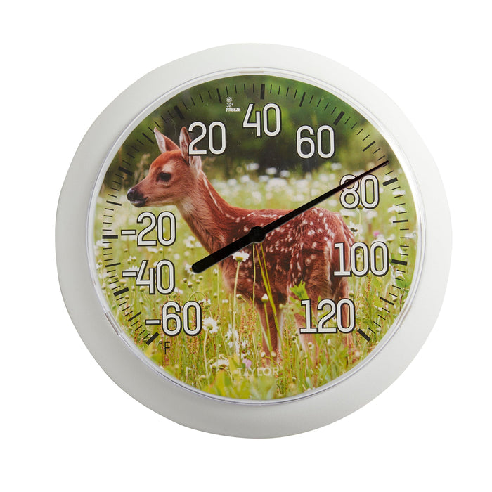 Close-up of a white framed outdoor thermometer featuring a fawn on a green dial