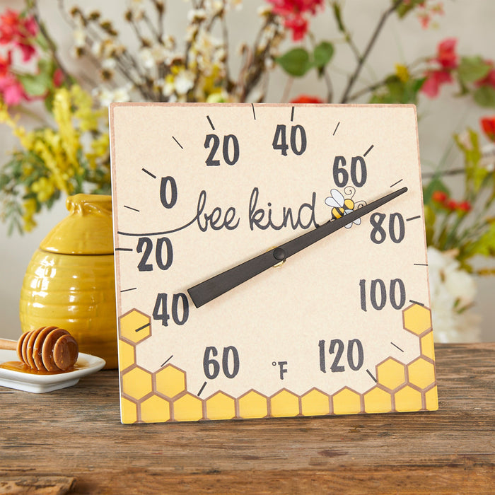 Bee Kind ceramic tabletop thermometer with stand featuring a bee and honeycomb design on a beige panel