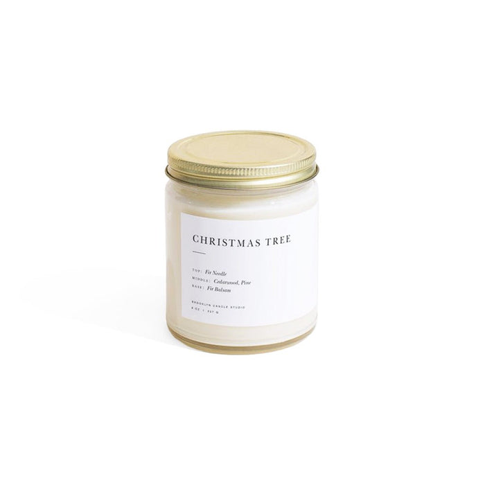 Candle jar labeled 'Christmas Tree' with a gold lid on a white background