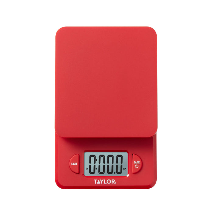 Red compact digital kitchen scale with pistachios scattered on a white surface
