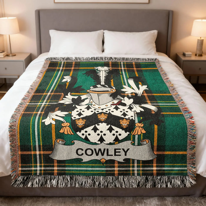 Cowley family crest woven blanket set out across a bed.