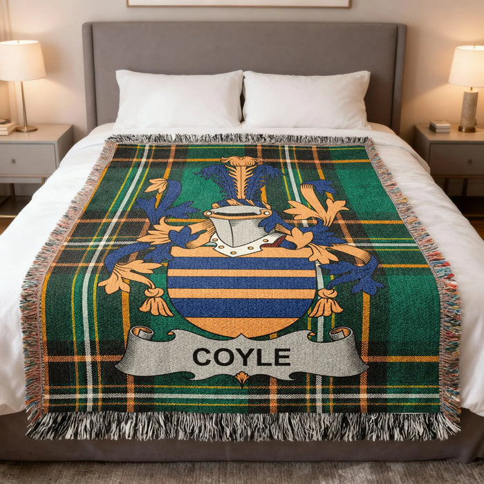Coyle family crest woven blanket spread on a bed.