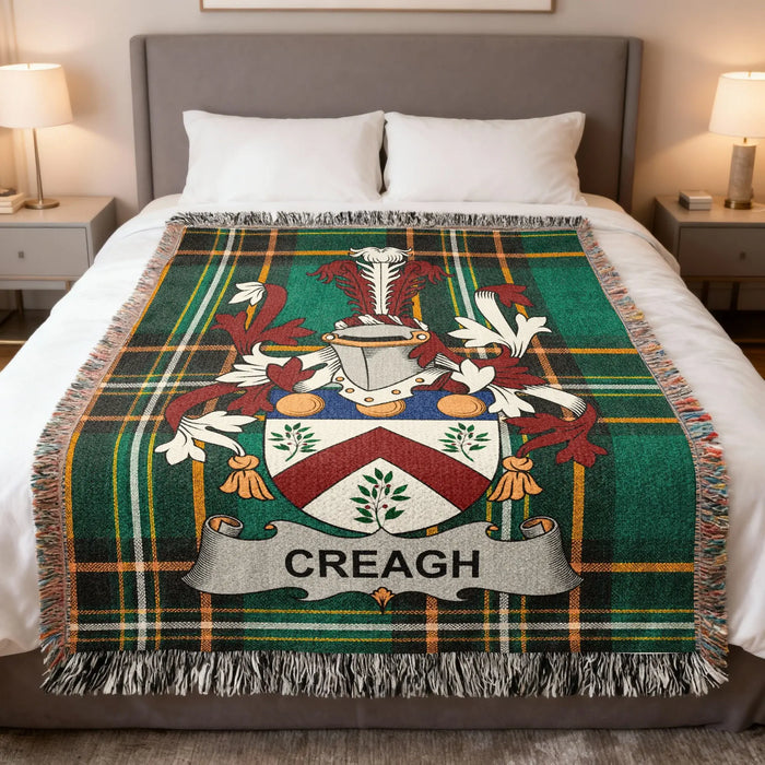 Creagh Irish family crest woven cotton blanket displayed on a bed