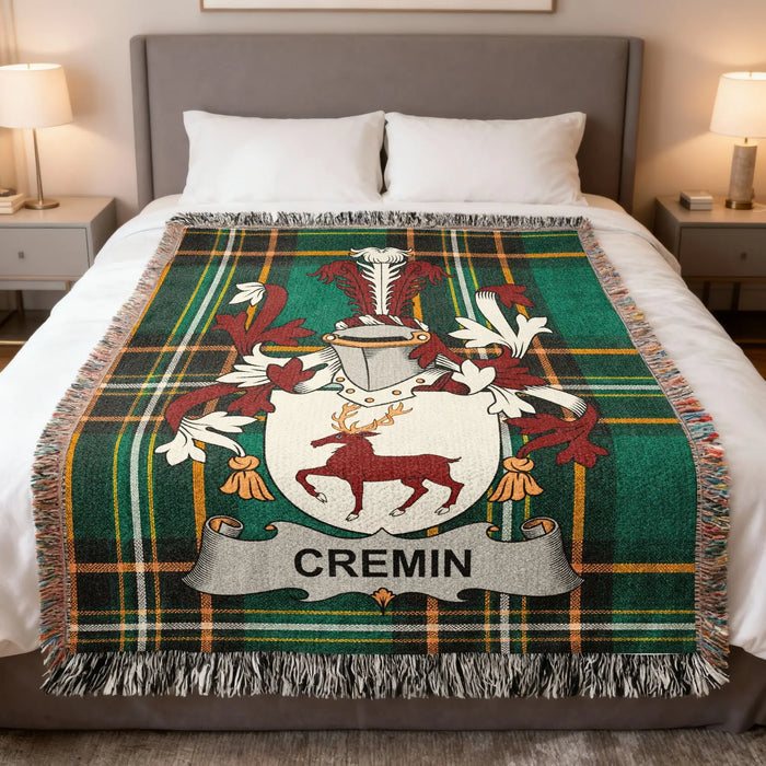 Cremin family crest woven blanket draped over a bed.