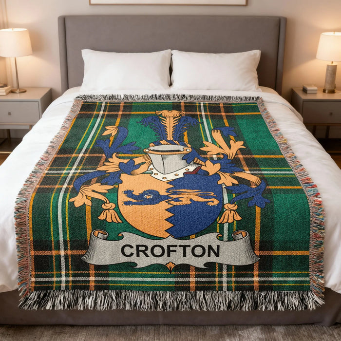 Crofton family crest woven blanket spread on a bed.