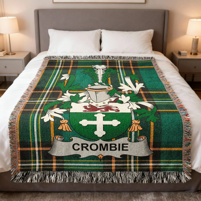 Crombie family crest woven blanket laid across a bed.
