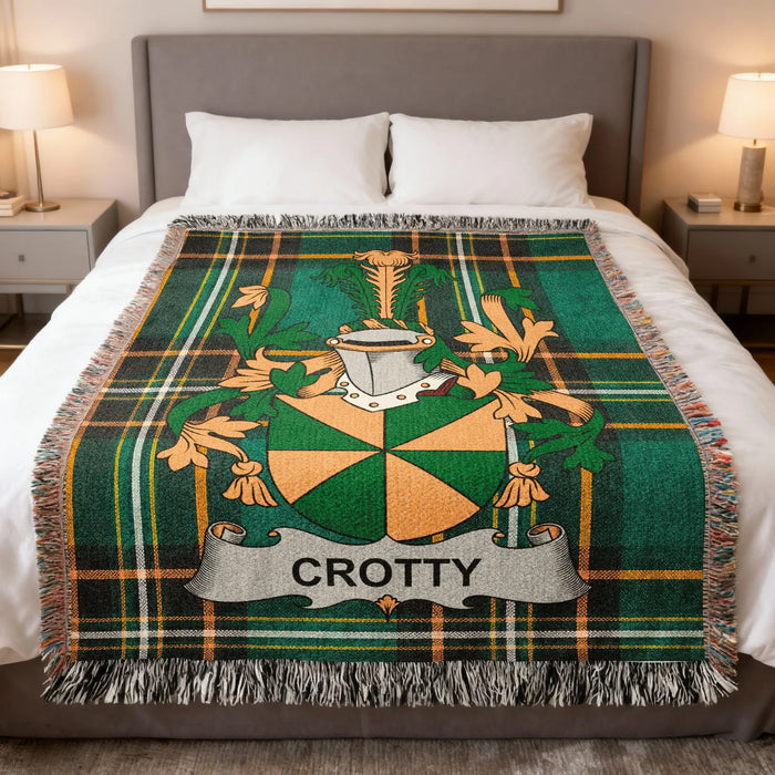 Crotty family crest woven blanket folded at the end of a bed.