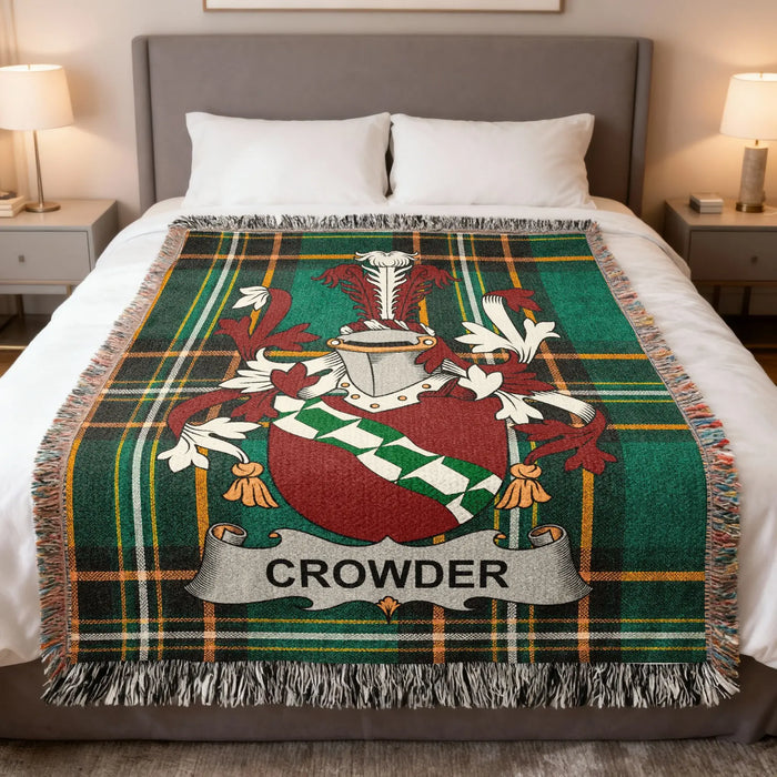 Crowder family crest woven blanket draped across a bed.