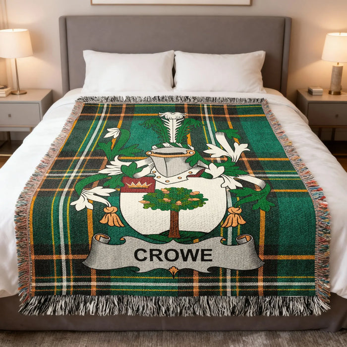 Crowe family crest woven blanket laid over a bed.