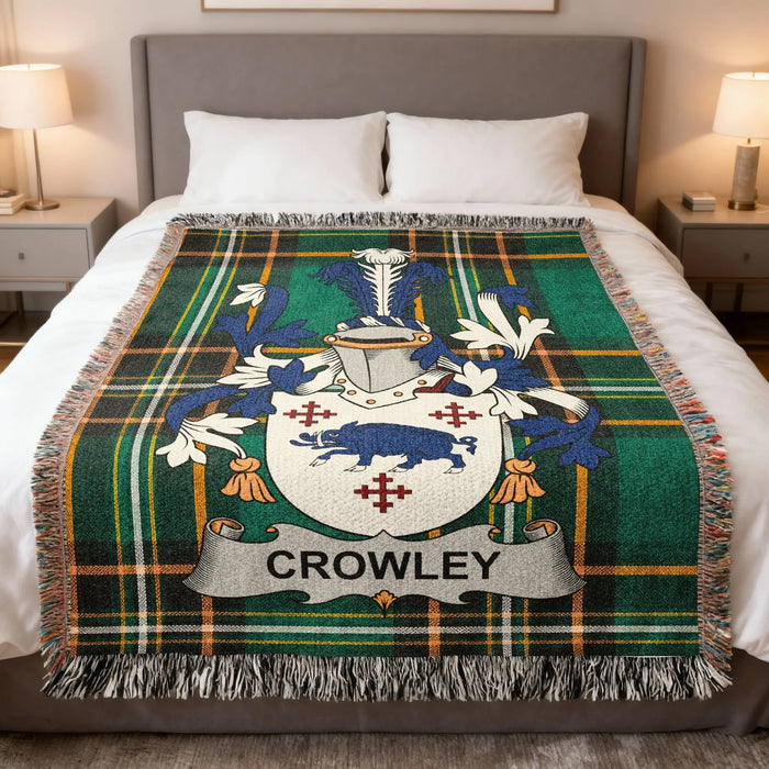 Crowley family crest woven blanket set out across a bed