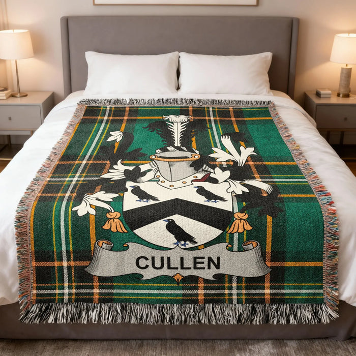 Cullen family crest woven blanket spread over a bed.