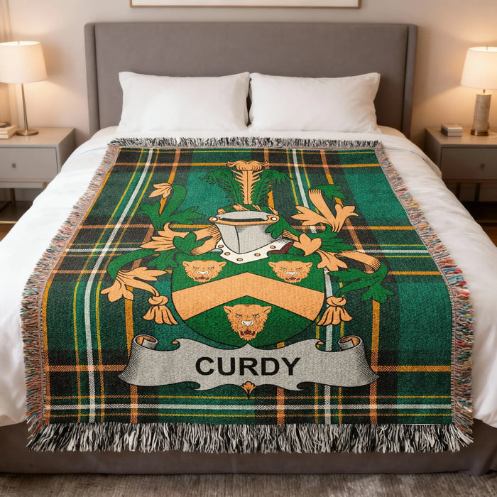 Curdy family crest woven blanket laid across a bed.