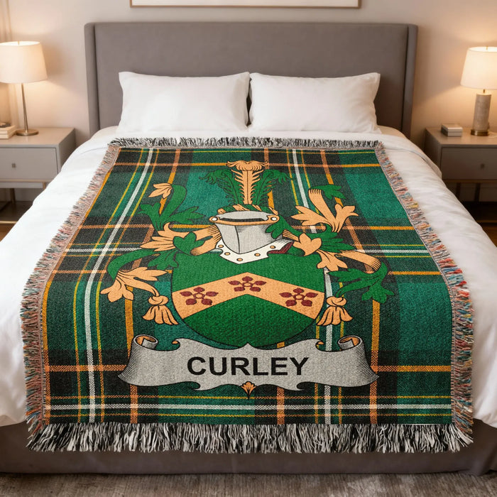 Curley family crest woven blanket draped across a bed.