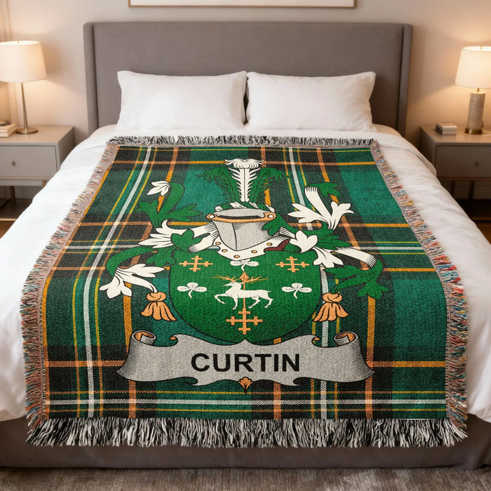 Curtin family crest woven blanket laid over a bed.