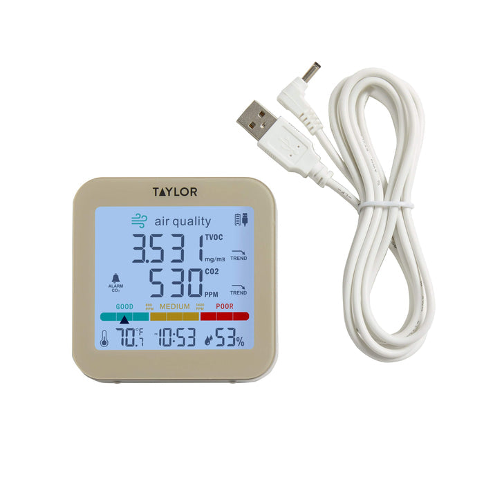 Taylor air quality monitor with USB power cord laid out beside it against a white background