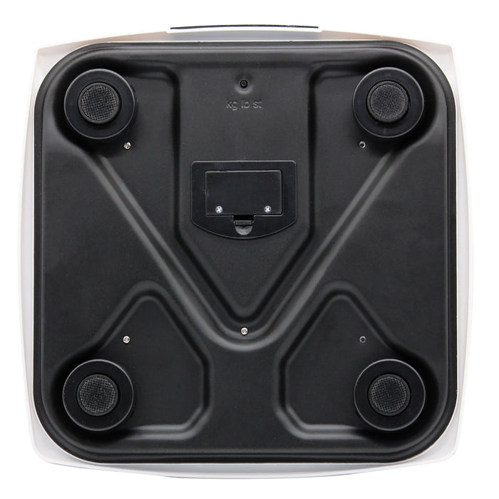Bottom view of white textured bathroom scale showing four feet and battery compartment