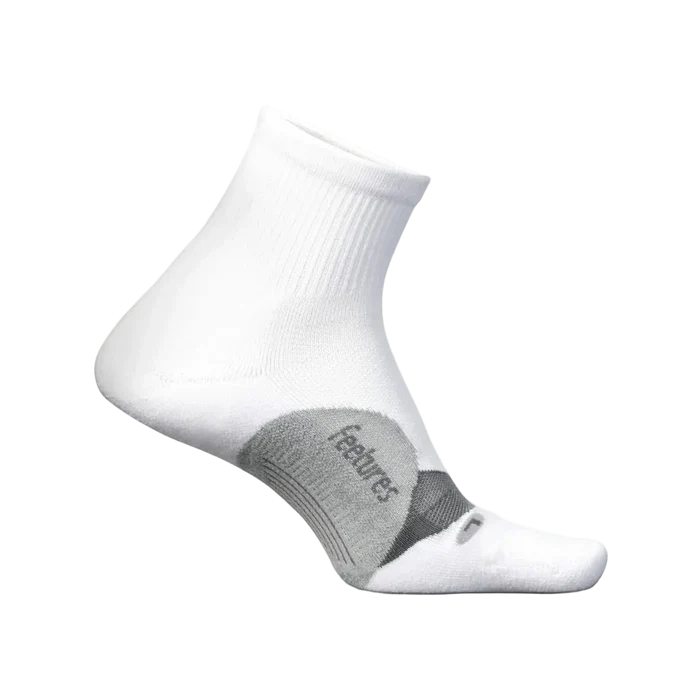 White sock with gray heel and toe area on a light beige background