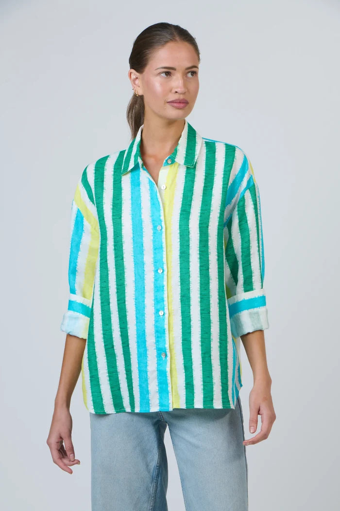 Woman wearing a green and white striped shirt against a plain background