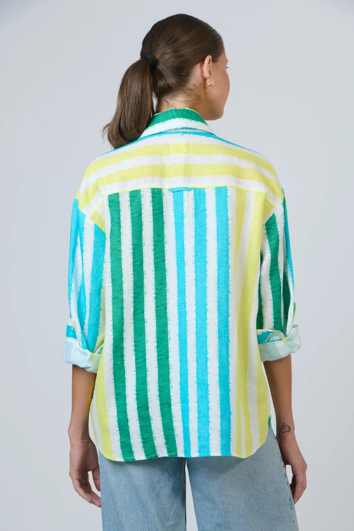 Person wearing a colorful striped shirt against a plain background