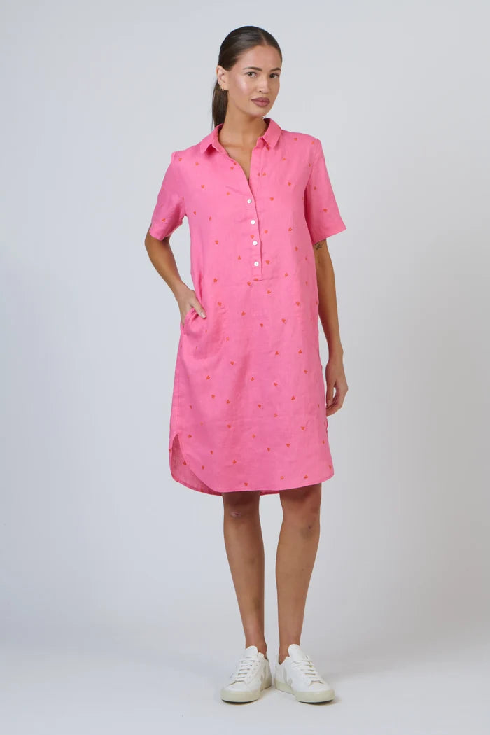 Woman wearing a pink dress with a white background