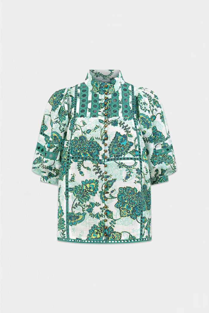 A short-sleeve button-up shirt with a high collar, featuring a green and teal floral pattern on a white background, displayed on a clean light gray studio background.