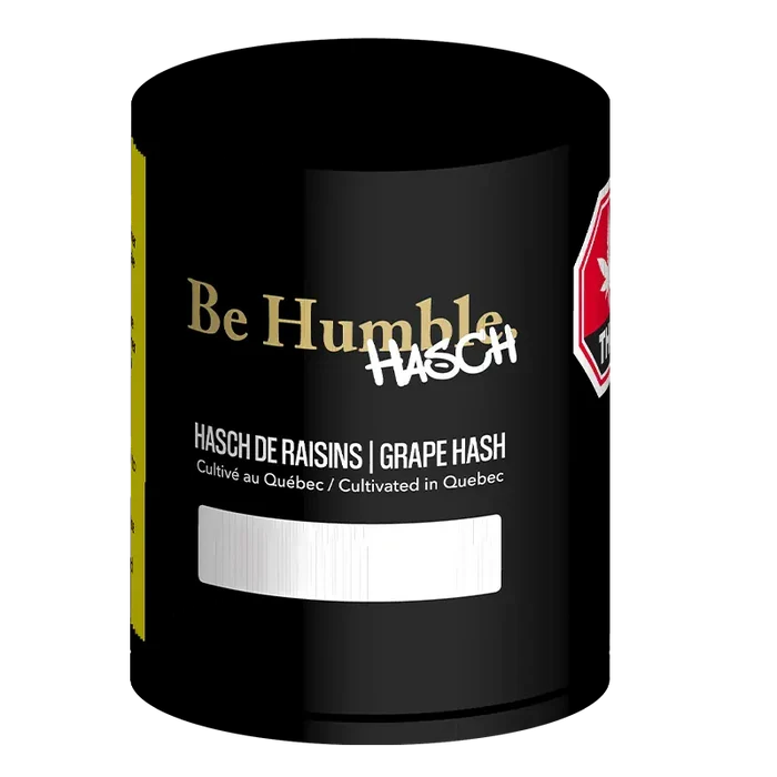Close-up front view of the black Be Humble Grape Hash canister with gold logo, white "HASCH" graffiti, and product text visible.
