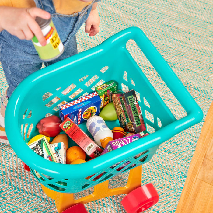 A blue, yellow, and red toy shopping cart complete with play food.
