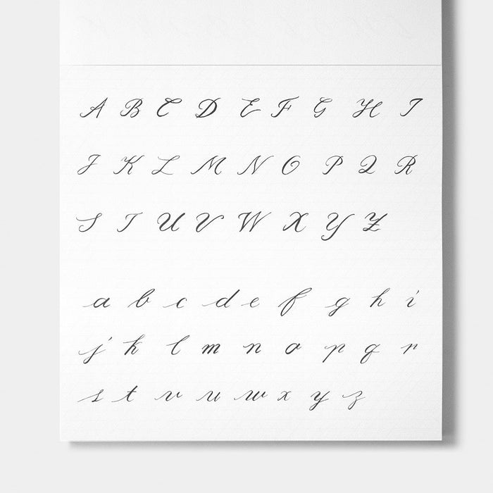 A white alphabet sheet showing uppercase and lowercase cursive script letters from A to Z in dark gray, photographed against a light gray background.