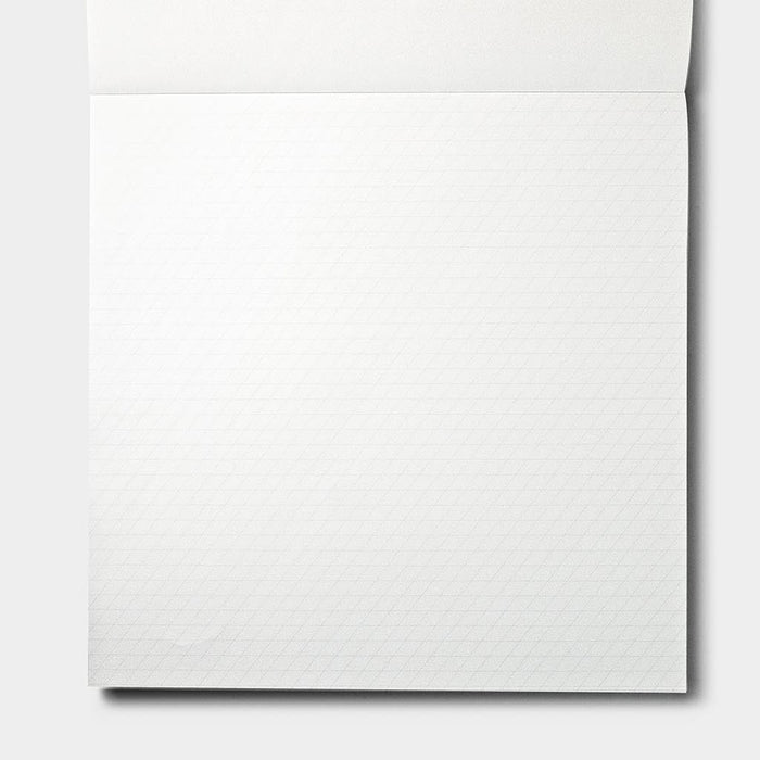 A close-up of a white textured paper sheet with a subtle grid pattern, shown against a light gray background.
