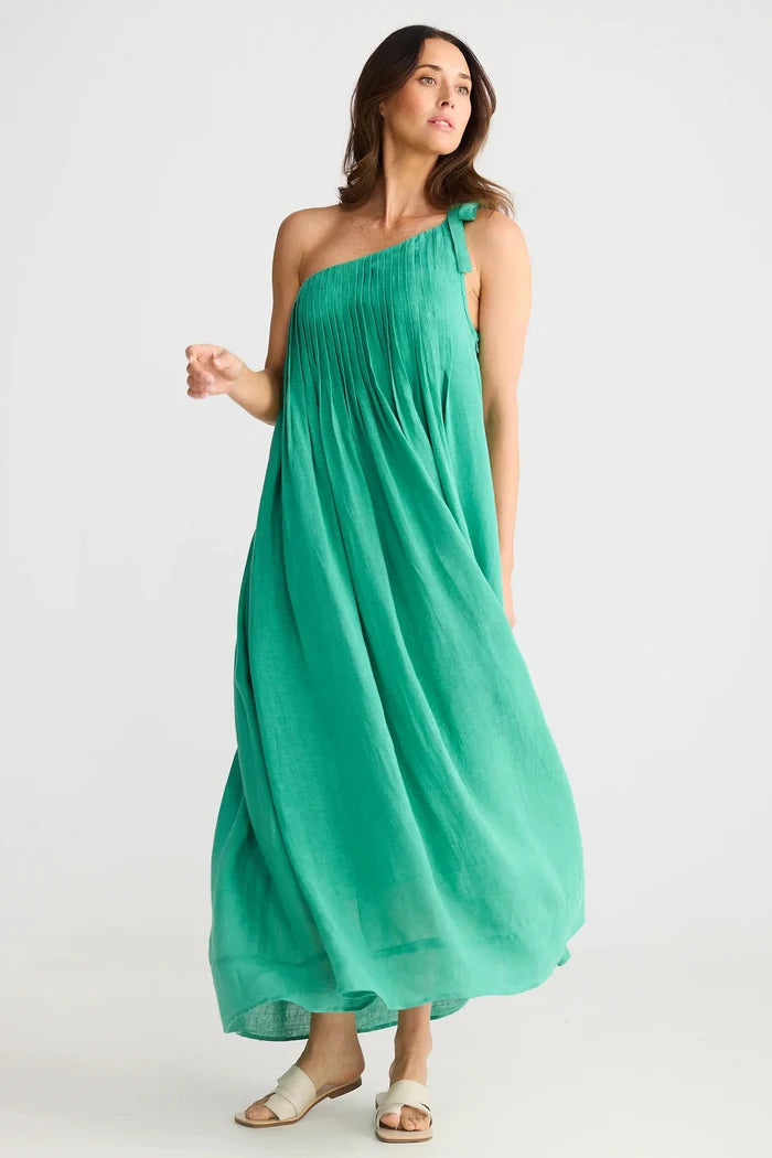 Woman wearing a green one-shoulder dress on a white background