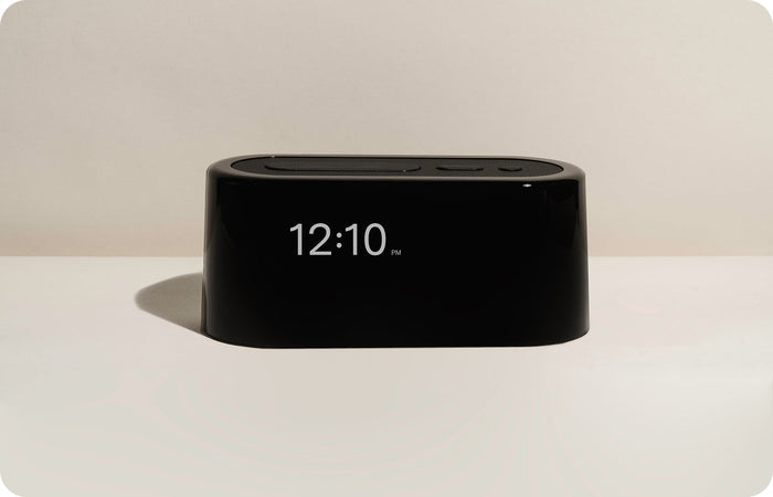 The nightlight, warm and low, on a nightstand