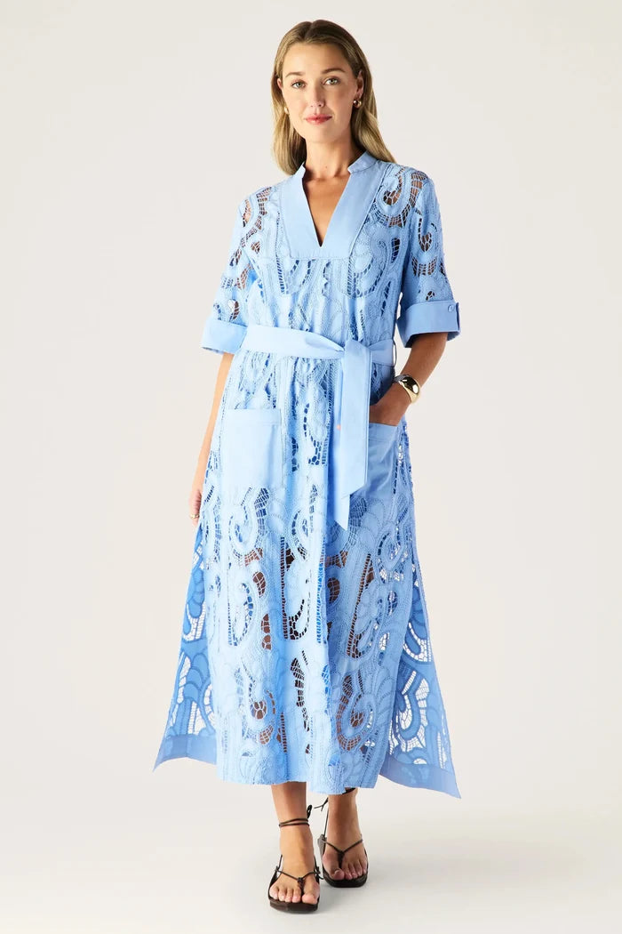 Woman wearing a blue floral dress on a white background