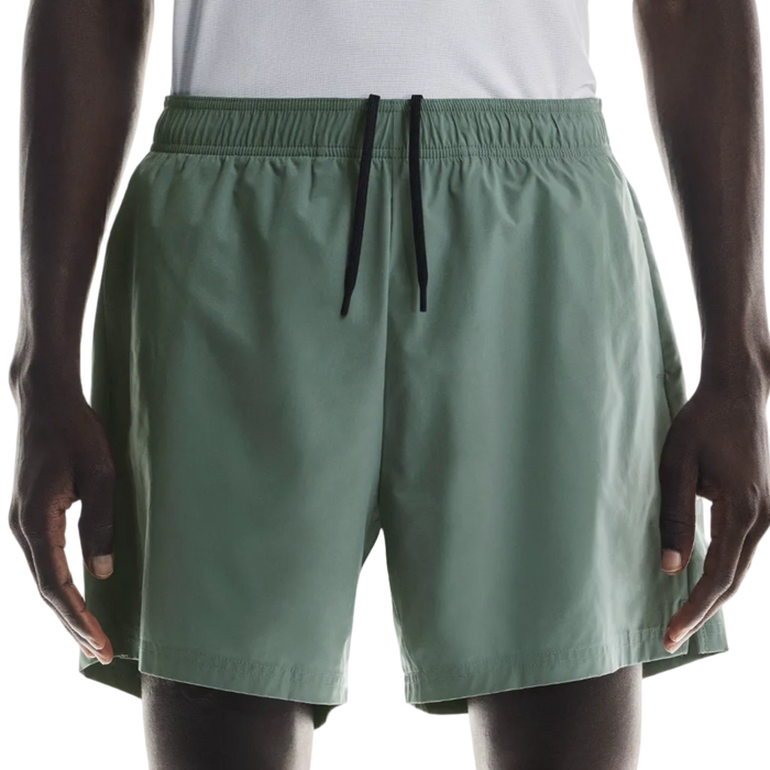 Person wearing green shorts on a white background