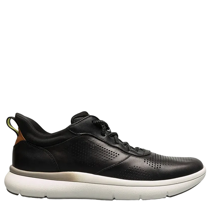Green sneaker with a beige sole on a light gray background