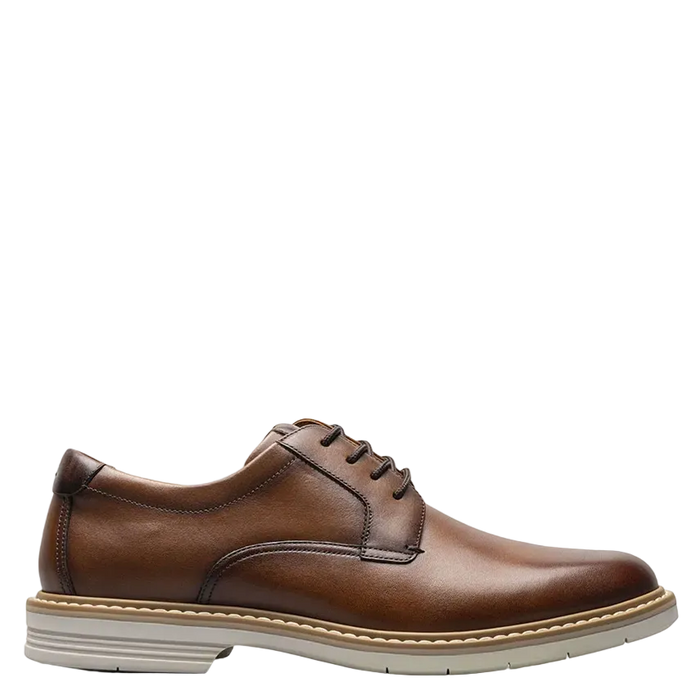 Brown leather dress shoe on a white background